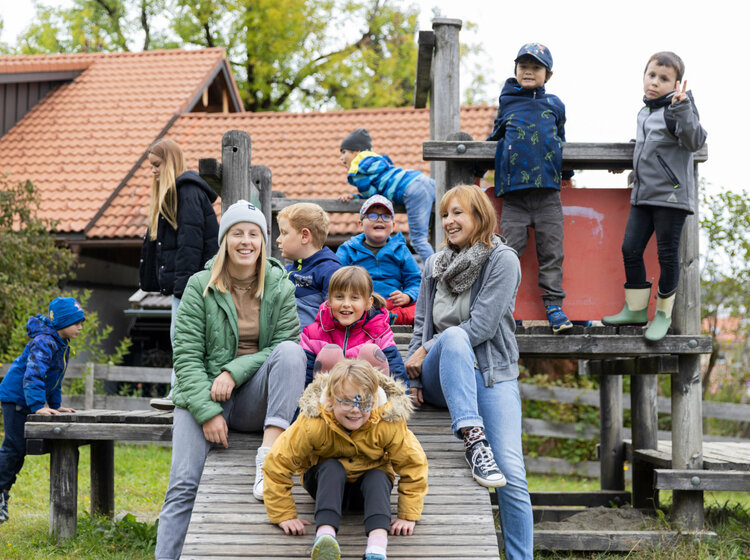 Zwei Frauen und mehrere Kinder auf einem Spielplatz